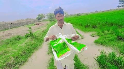 Farmer holding SACI Sadan bags